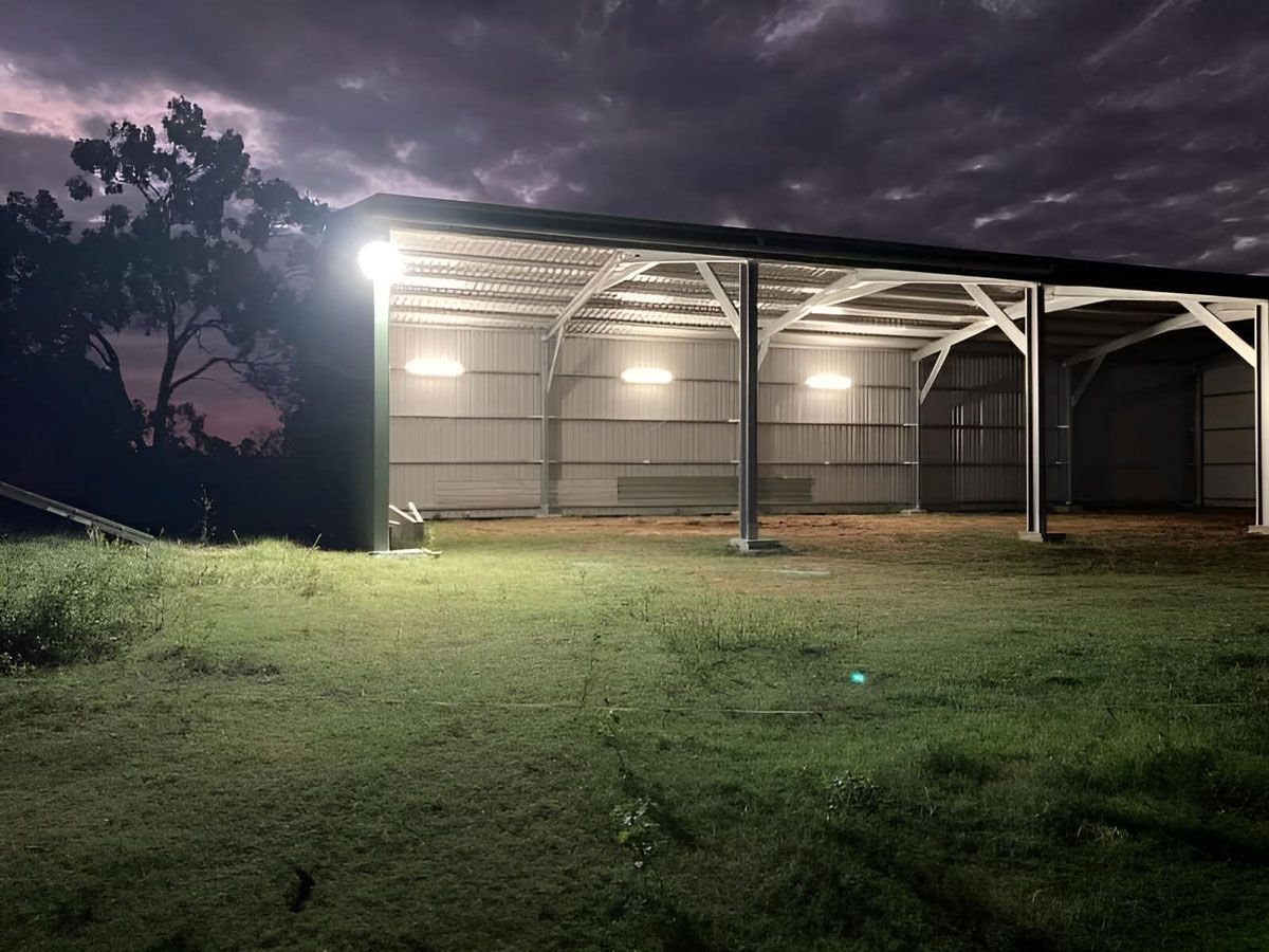 A Barn is Lit Up at Night With a Lot of Lights on It — Mbah Metal Roofing in South Brunswick Heads, NSW