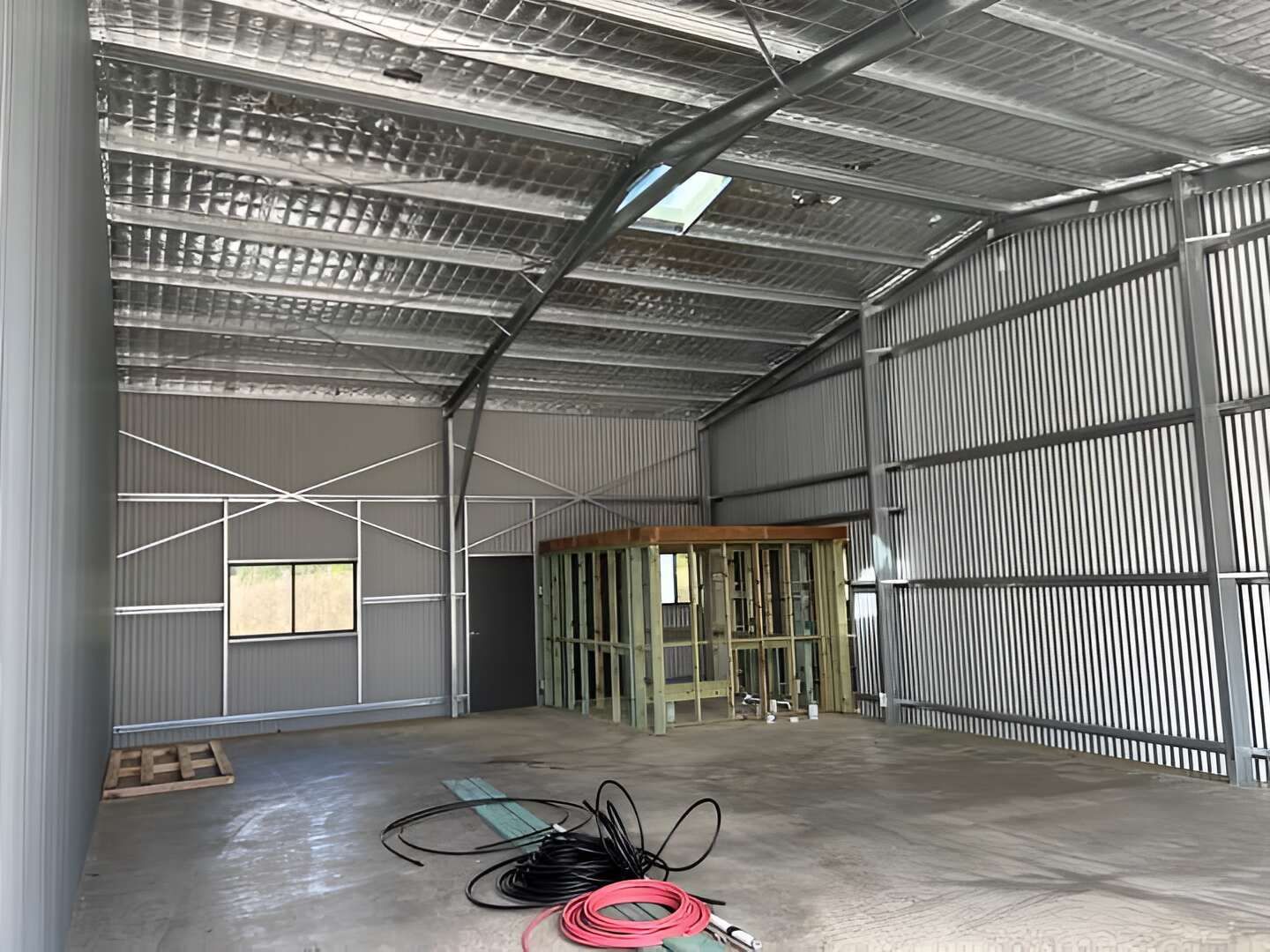 A Large Warehouse With A Roof That Is Covered In Aluminum Foil — Mbah Metal Roofing In Murwillumbah, NSW