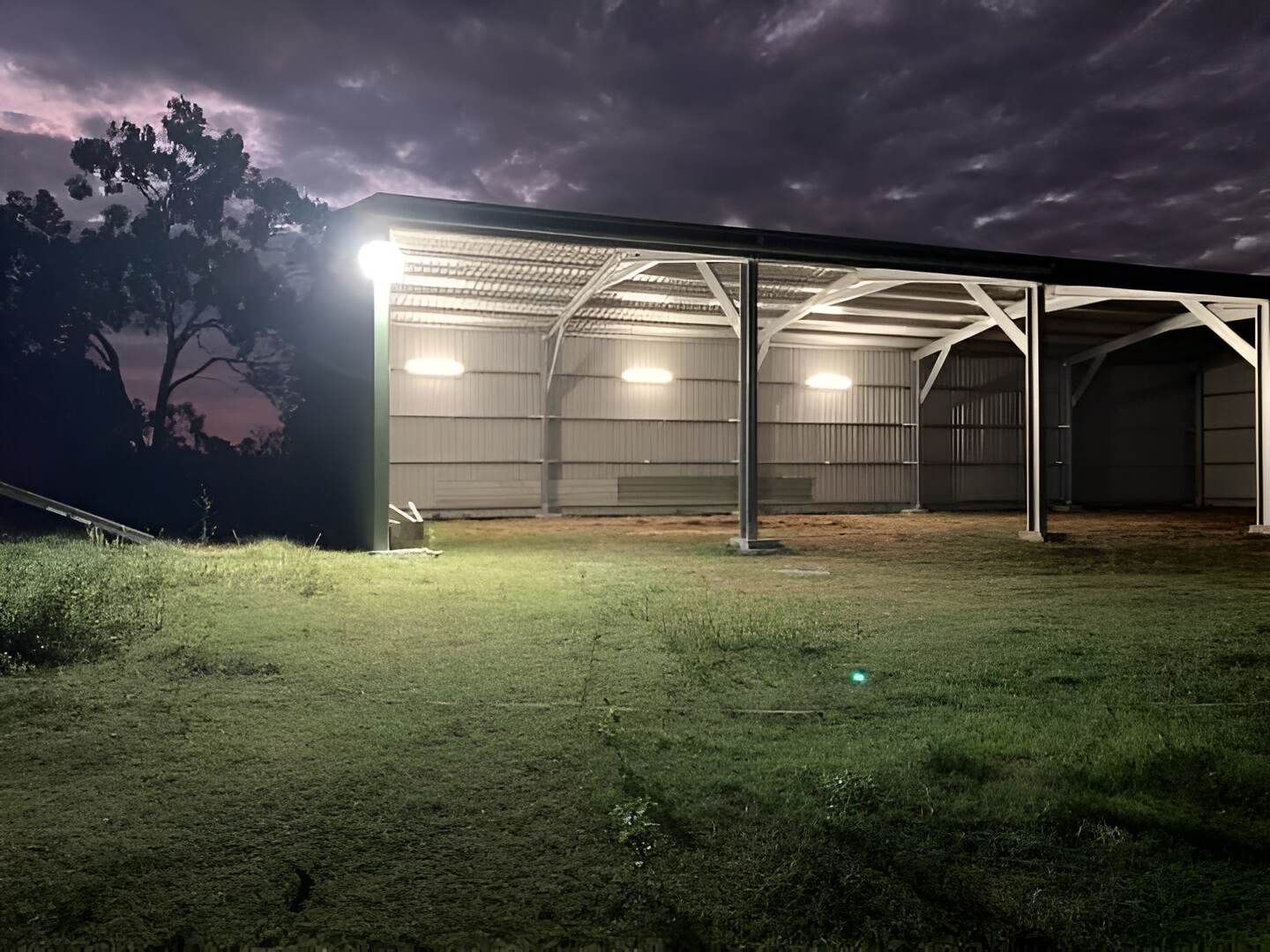 A Barn Is Lit Up At Night With A Lot Of Lights On It — Mbah Metal Roofing In Murwillumbah, NSW