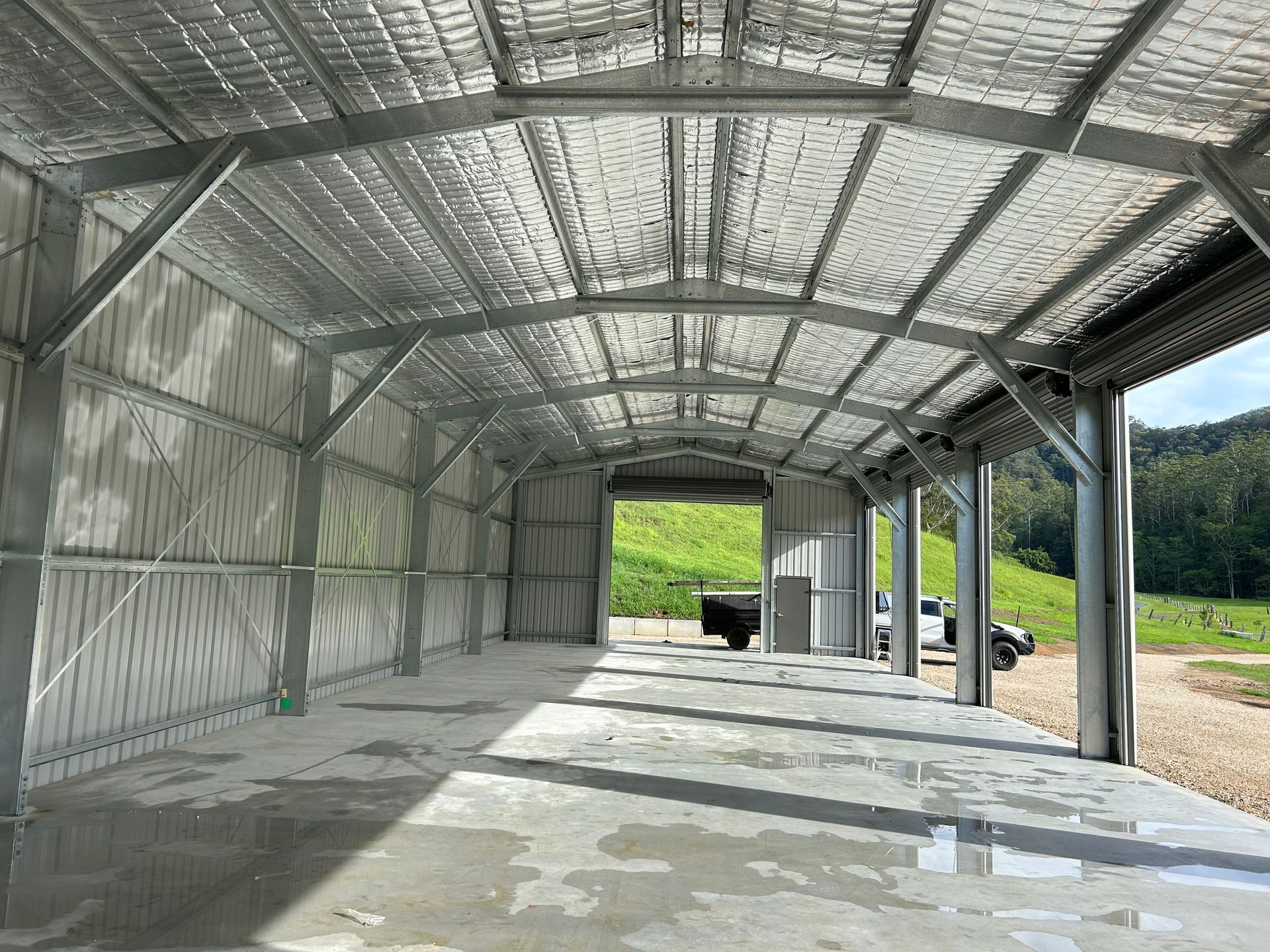 The Inside Of A Large Metal Building With A Concrete Floor — Mbah Metal Roofing In Murwillumbah, NSW