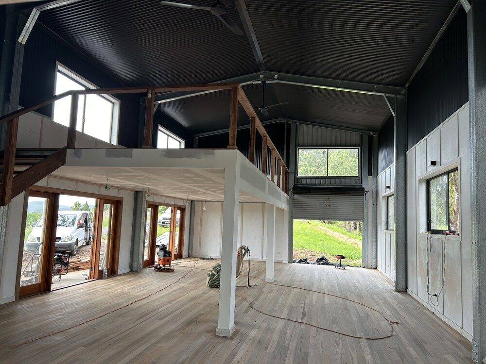 A Large Room With A Balcony And Lots Of Windows — Mbah Metal Roofing In Murwillumbah, NSW