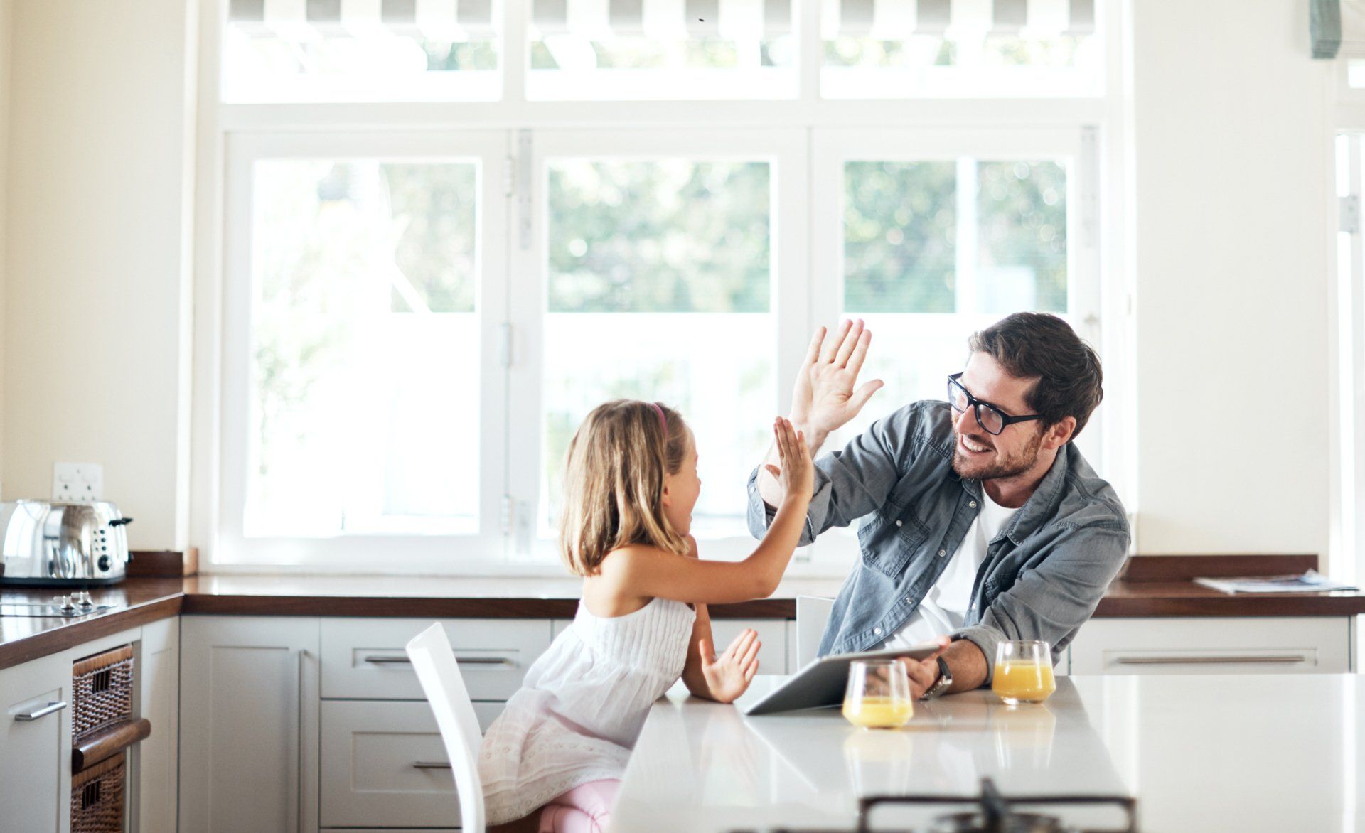 dad and daughter high five in kitchen