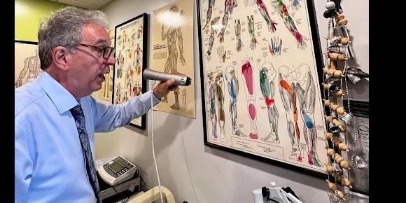 An image of chiropractor looking of his chart