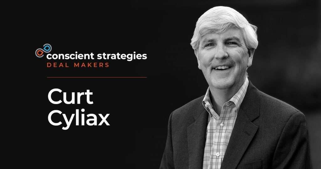 Curt Cyliax, smiling in a blazer, with the 