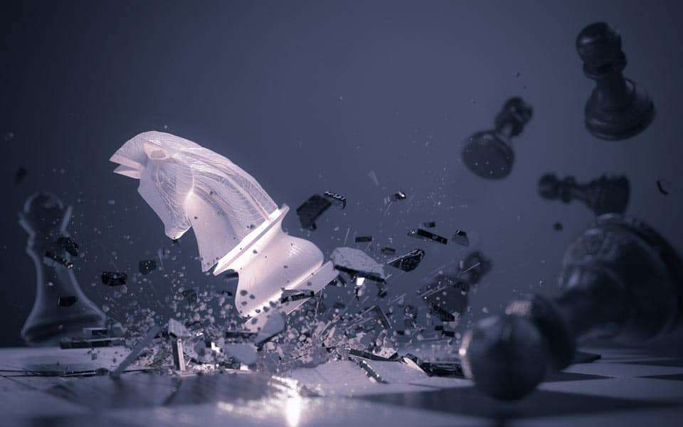 Chess knight shattering; fragments and other pieces scattered against a dark background.