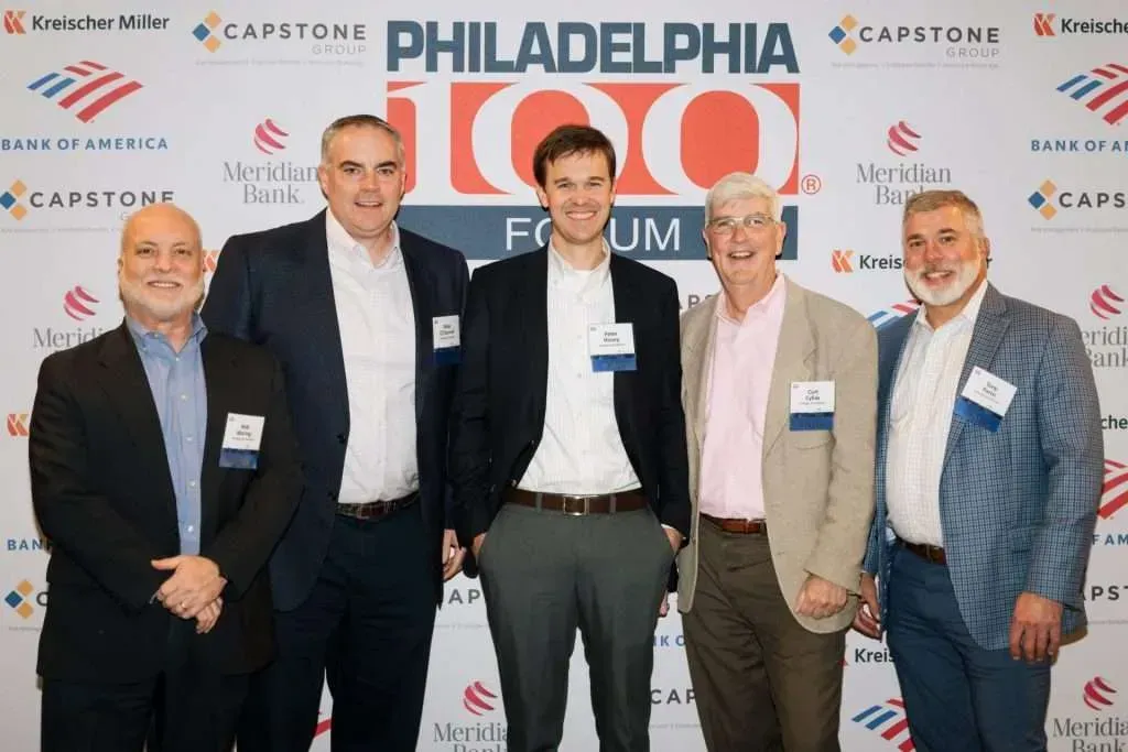 Five men pose for a photo at the Philadelphia 100 Forum.