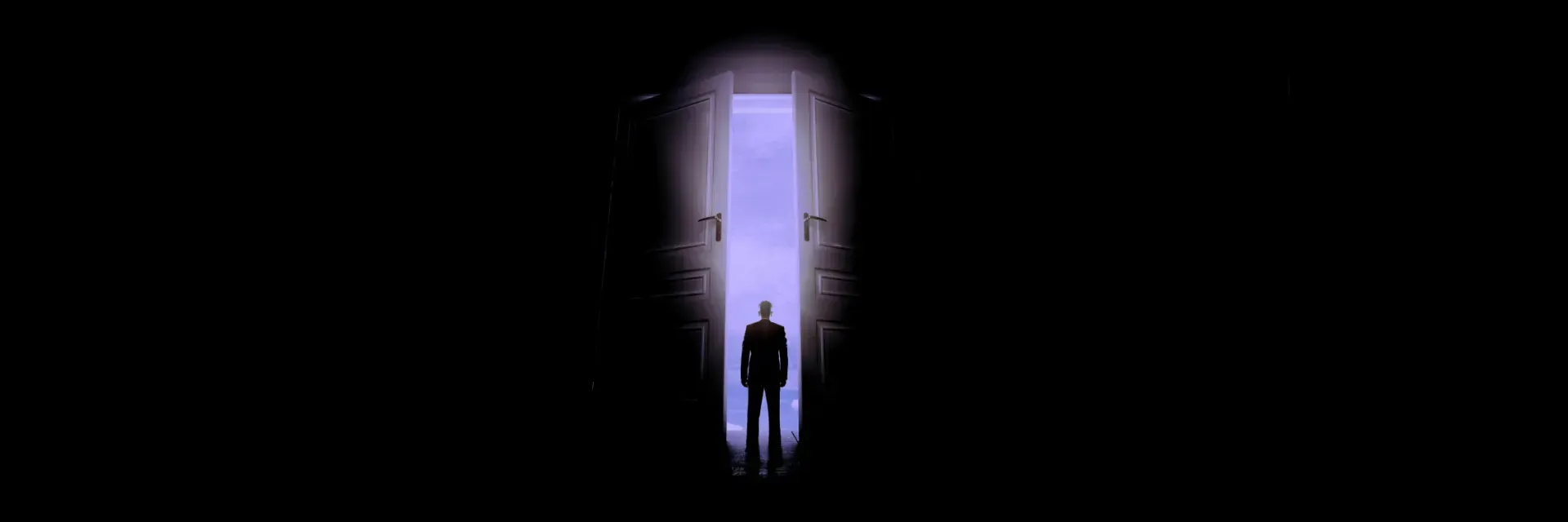Silhouette of a person standing in a doorway emitting bright light in a dark room.