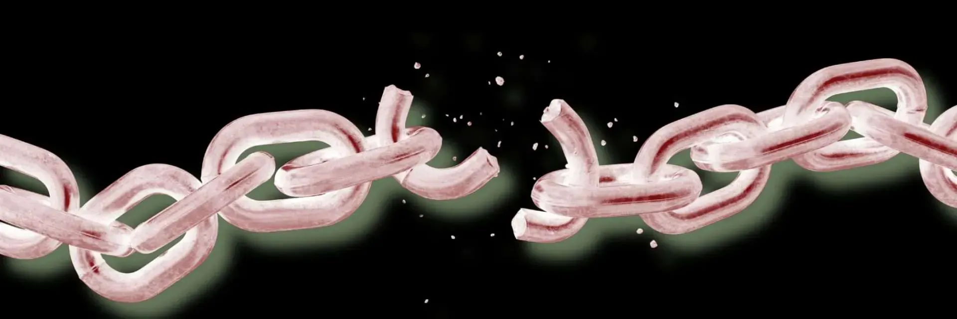 A chain breaking apart with a black background, representing freedom.