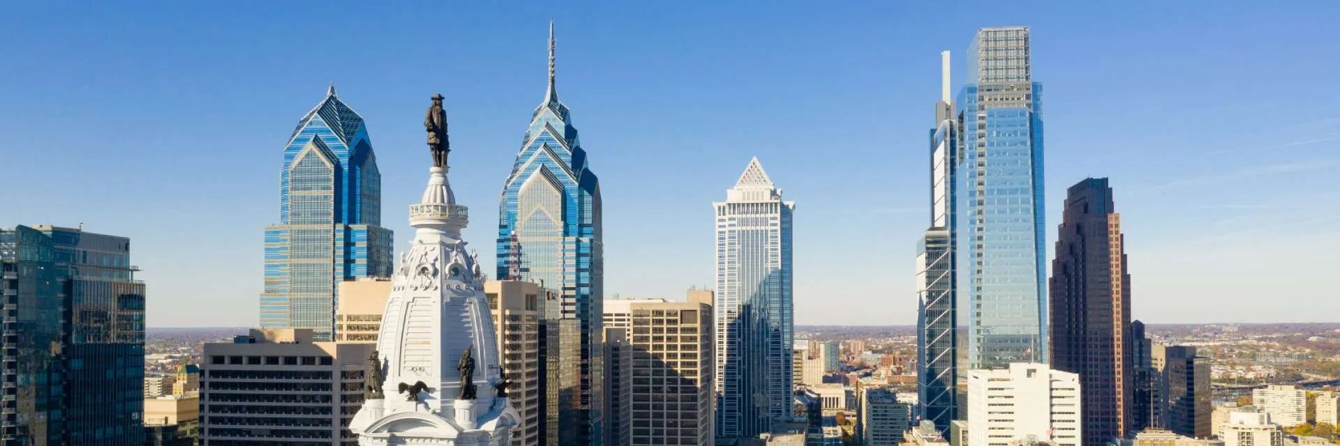 Philadelphia skyline with skyscrapers and clear blue sky.