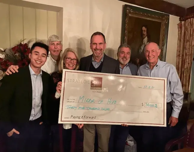 Group holds large check for 