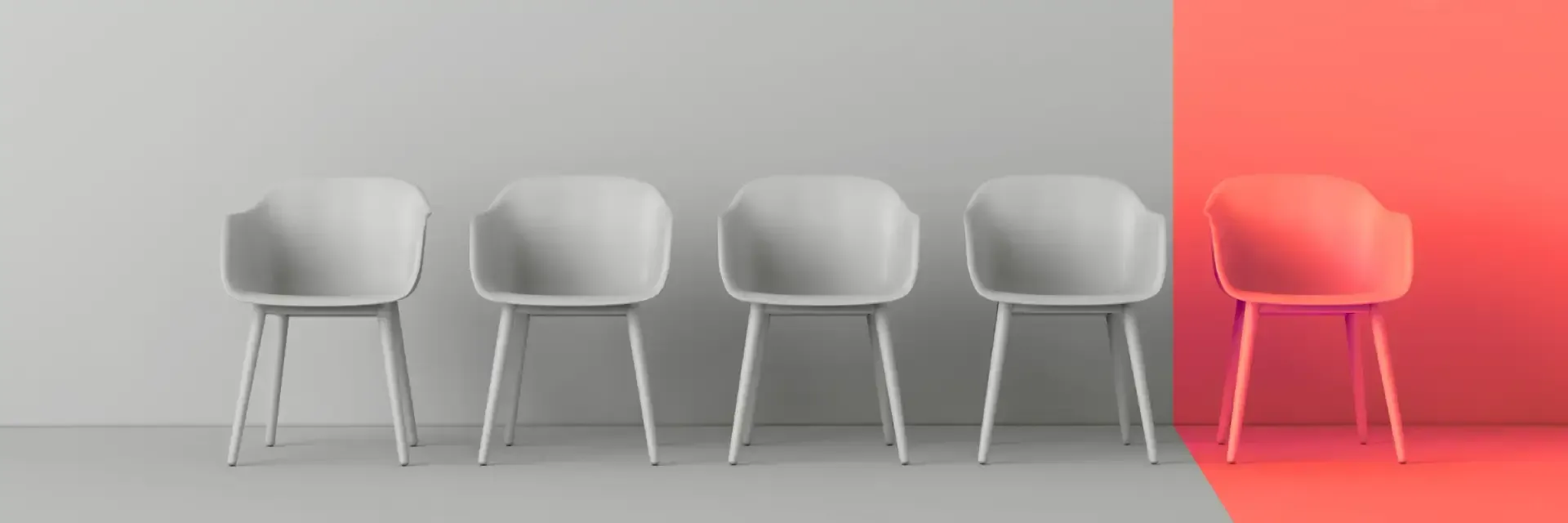 Five white chairs, one is in red, against a gray and red backdrop.