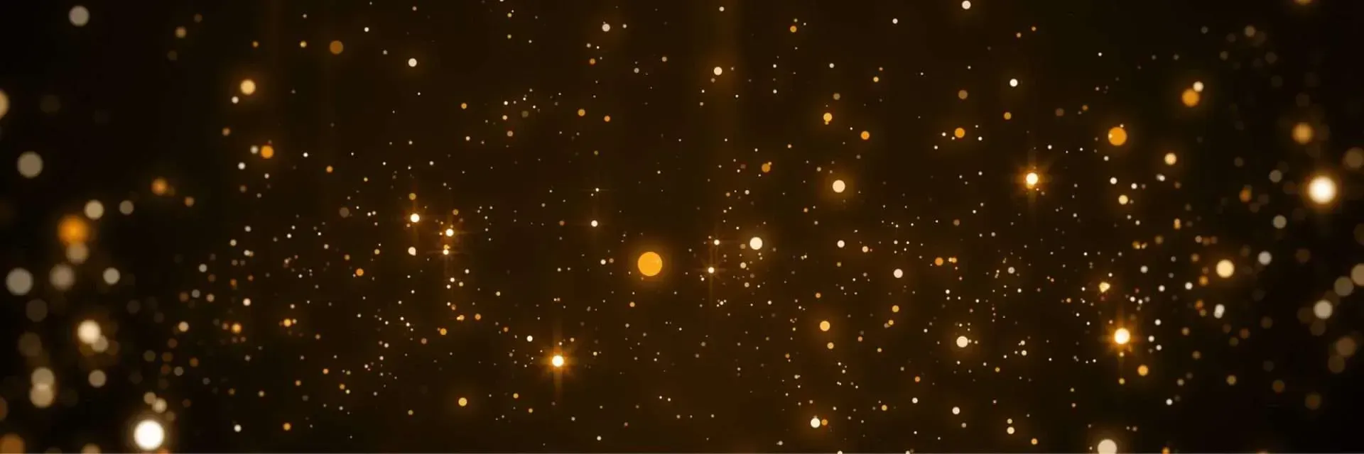 Golden sparkling bokeh effect against a dark background.