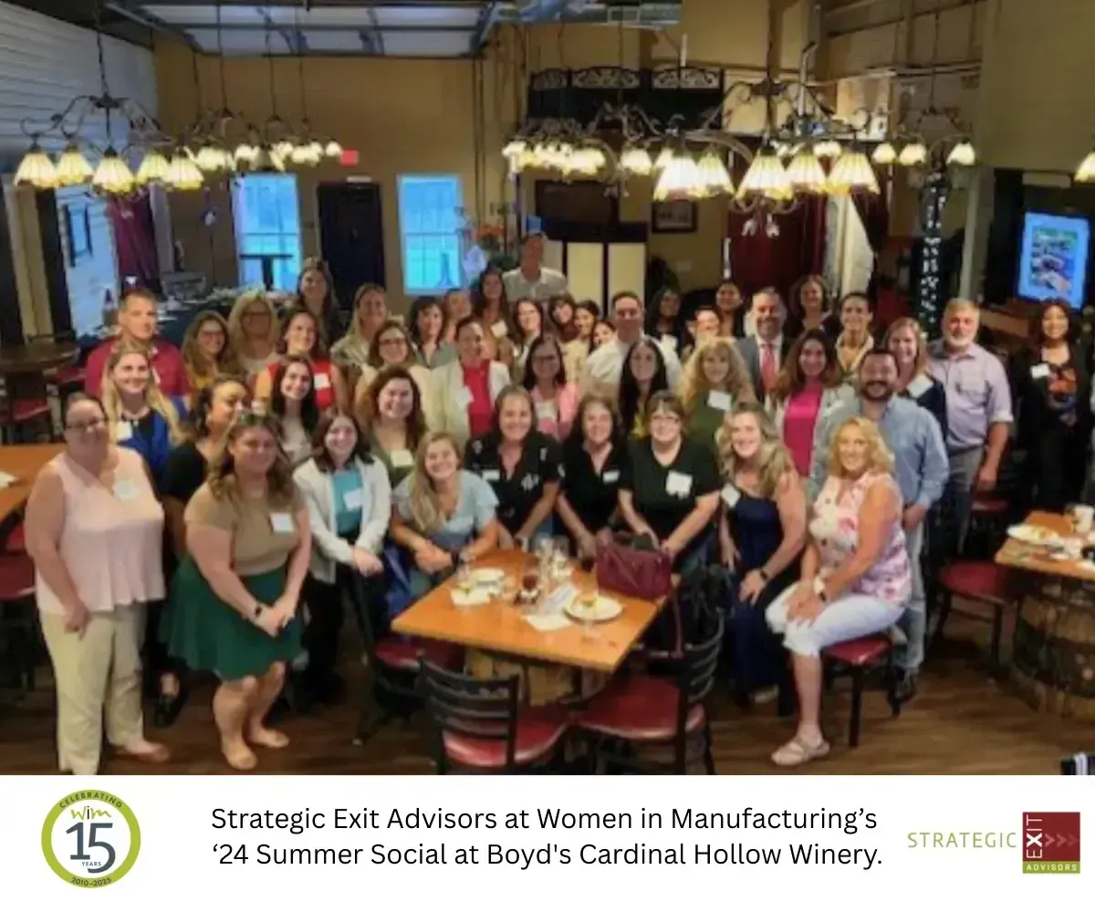 Group photo at a winery social event. People are gathered indoors at Boyd's Cardinal Hollow Winery.