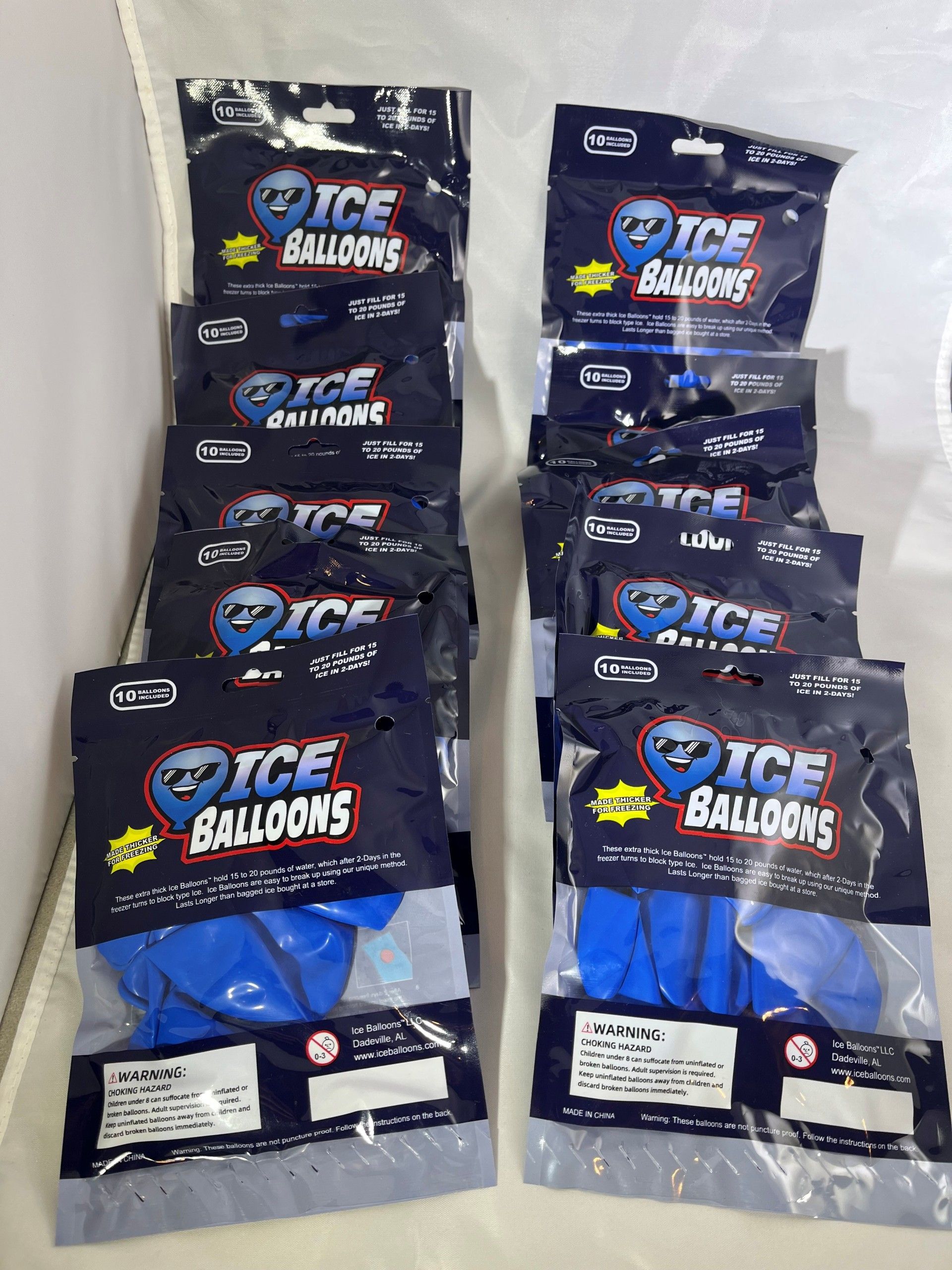 Several packs of blue balloons in clear plastic, stacked together.