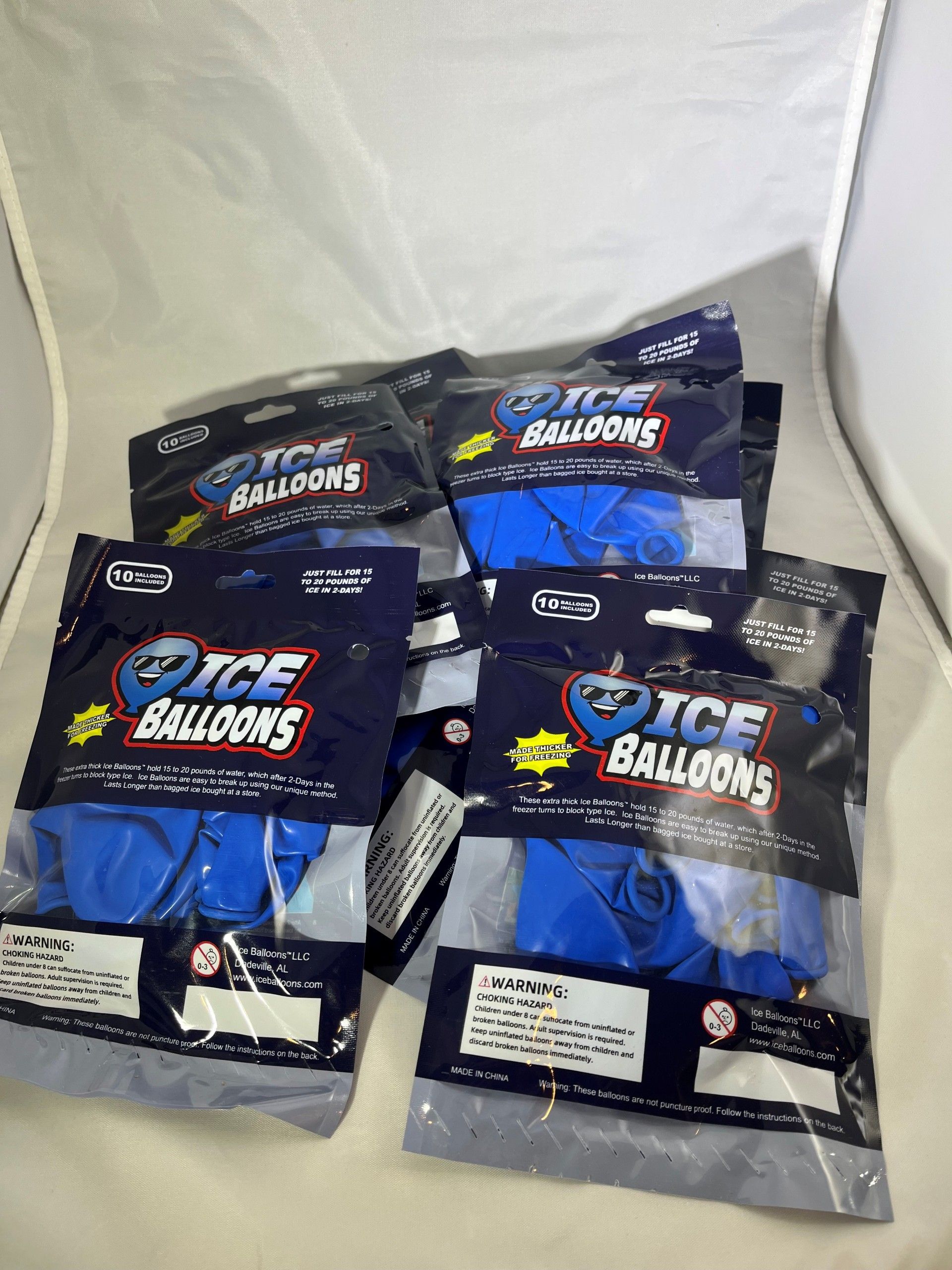 Six sealed packages of blue "Ice Balloons" on a white surface.