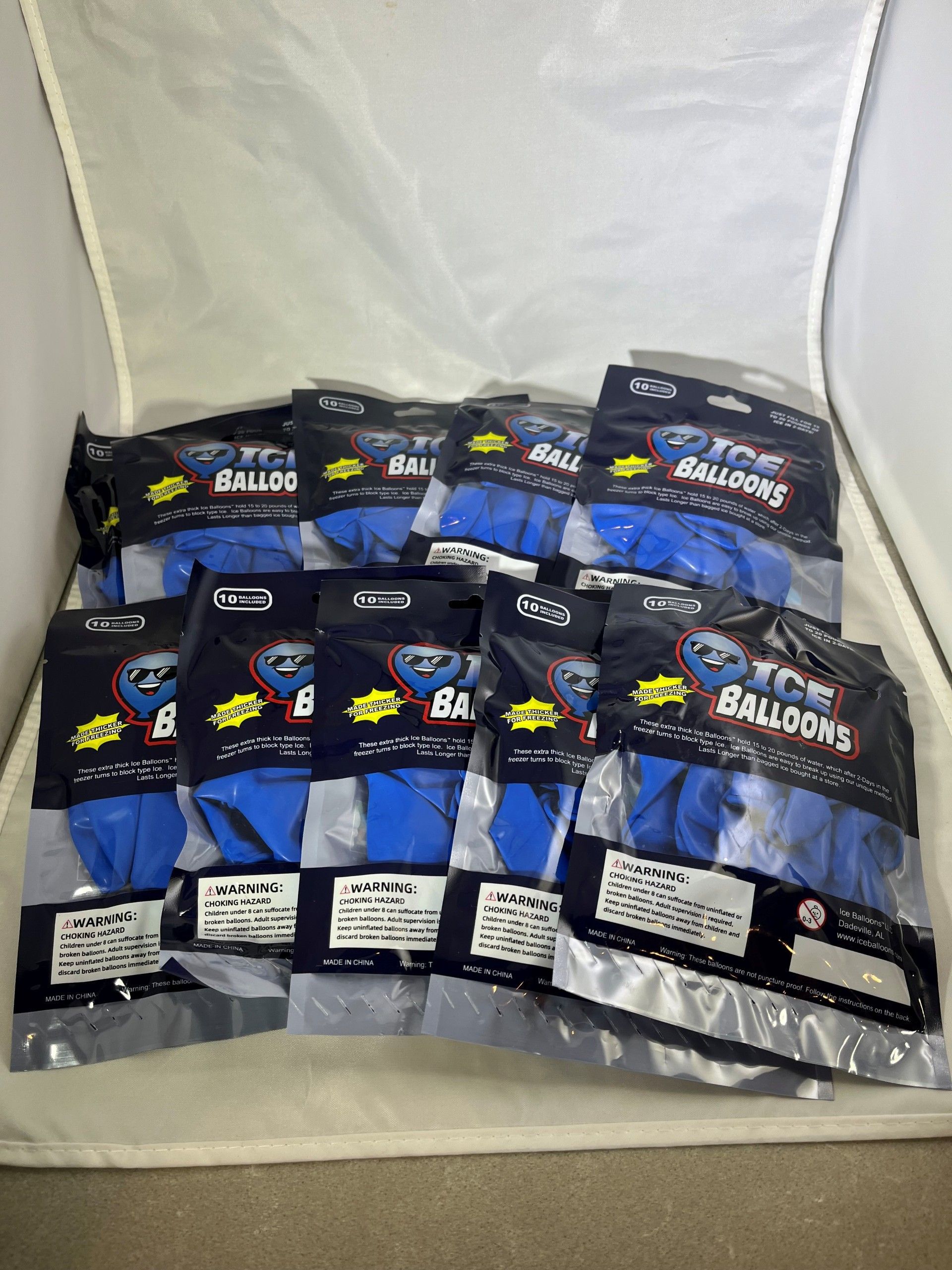 Several packs of blue balloons in clear plastic, stacked together.