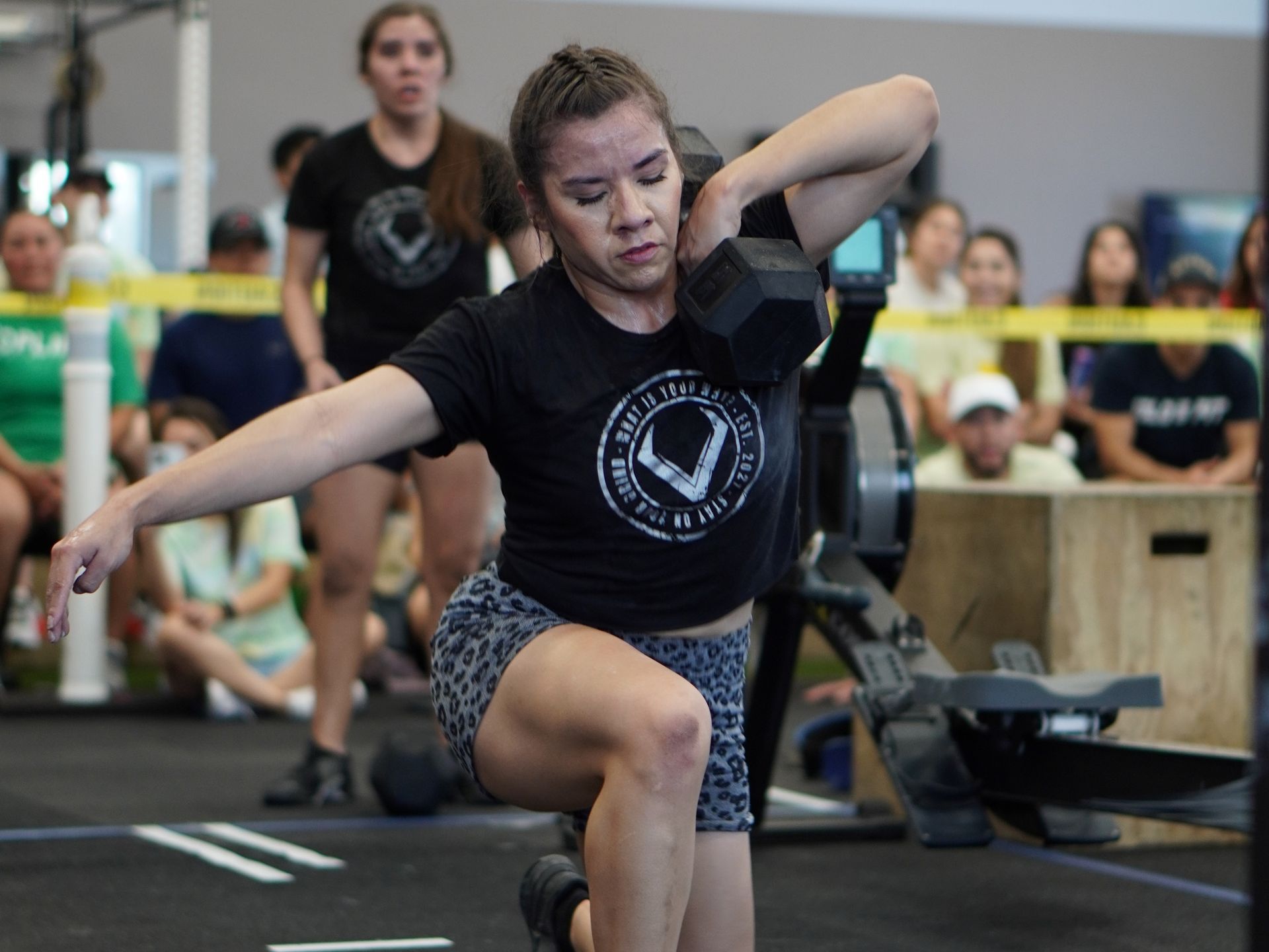 a man is lifting a barbell in a gym .