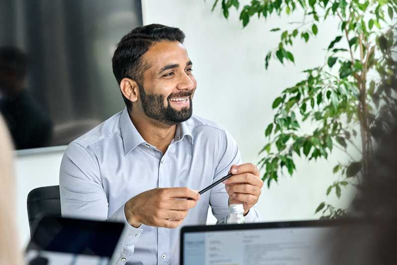 Happy Middle Eastern man in office