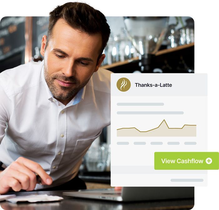 Restaurant owner viewing business cashflow on laptop