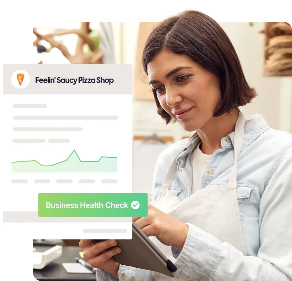 Female takeaway owner looking at a tablet at work