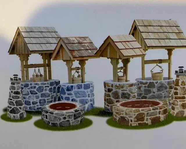A group of stone wells with wooden roofs
