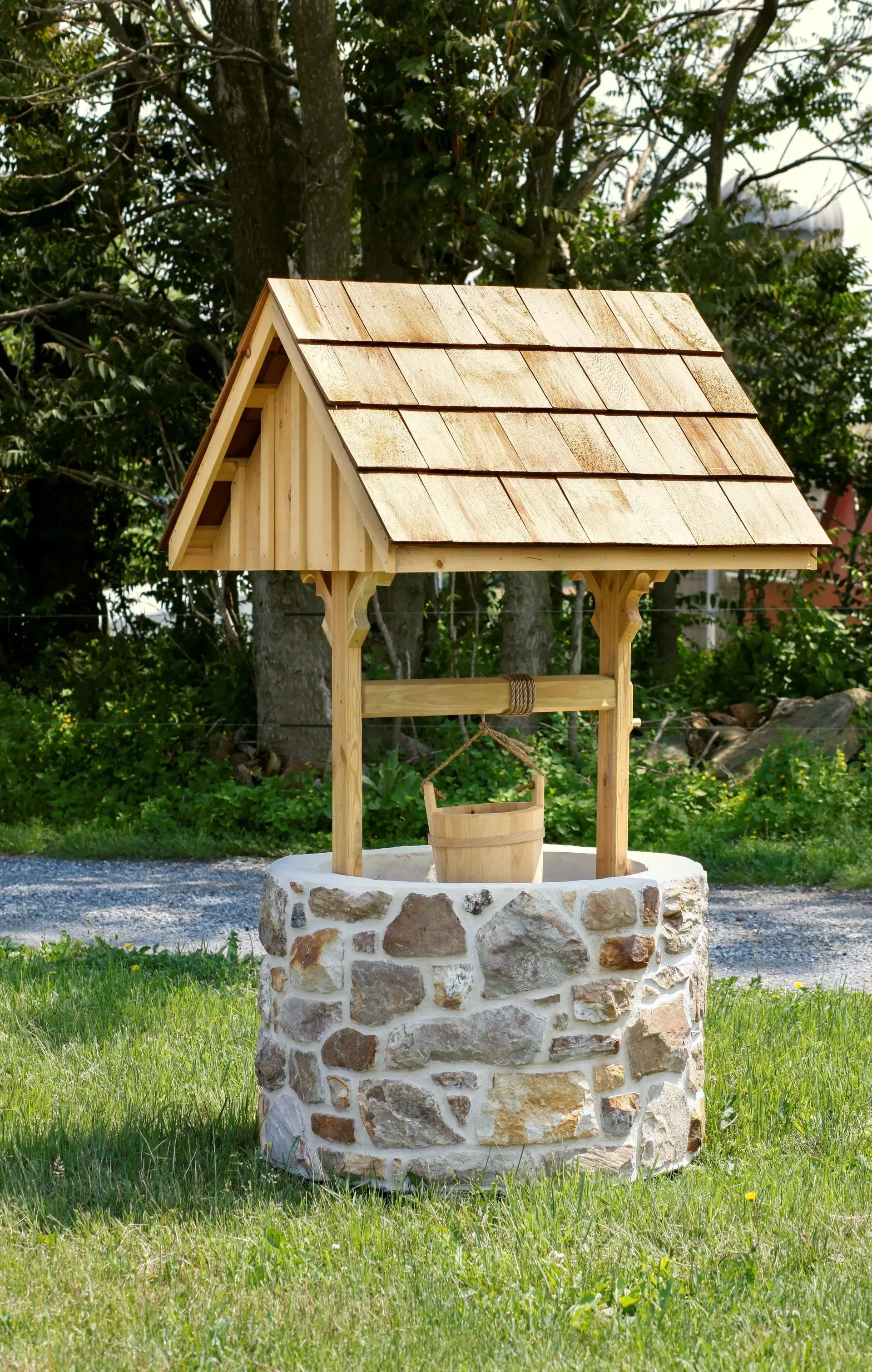 A stone well with a wooden roof and bucket