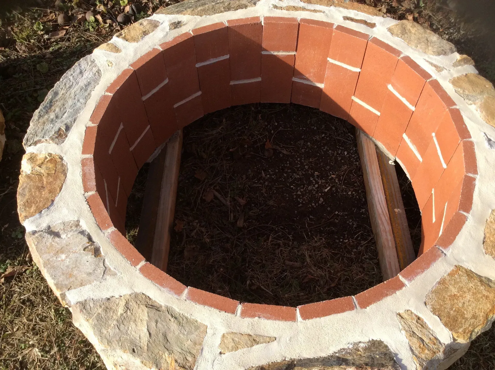 A fire pit made out of bricks and rocks