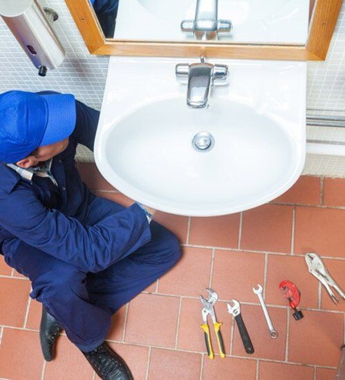 Plumber Repairing Sink — Kitchen Remodeling in Stamford, CT