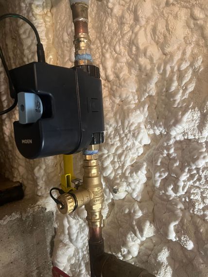 Plumber Fixing Sink in Bathroom — Bathroom Remodeling in Stamford, CT