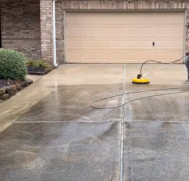 A person is cleaning a tiled roof with a high pressure washer.
