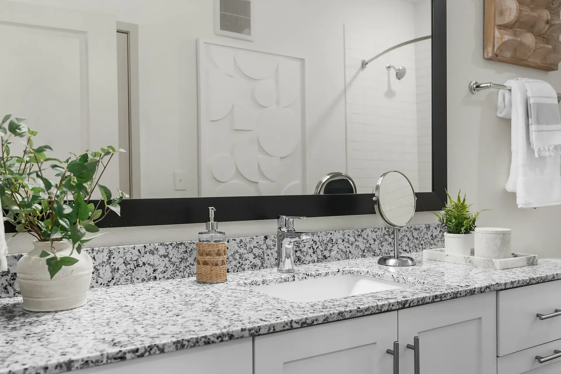 Experience elegance with this beautifully designed bathroom vanity, adorned with a granite countertop and tasteful accents.