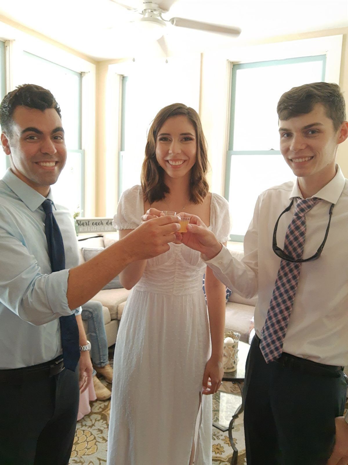 The bride, the groom, and a friend toasting after the wedding at The Laurel Oak Inn.