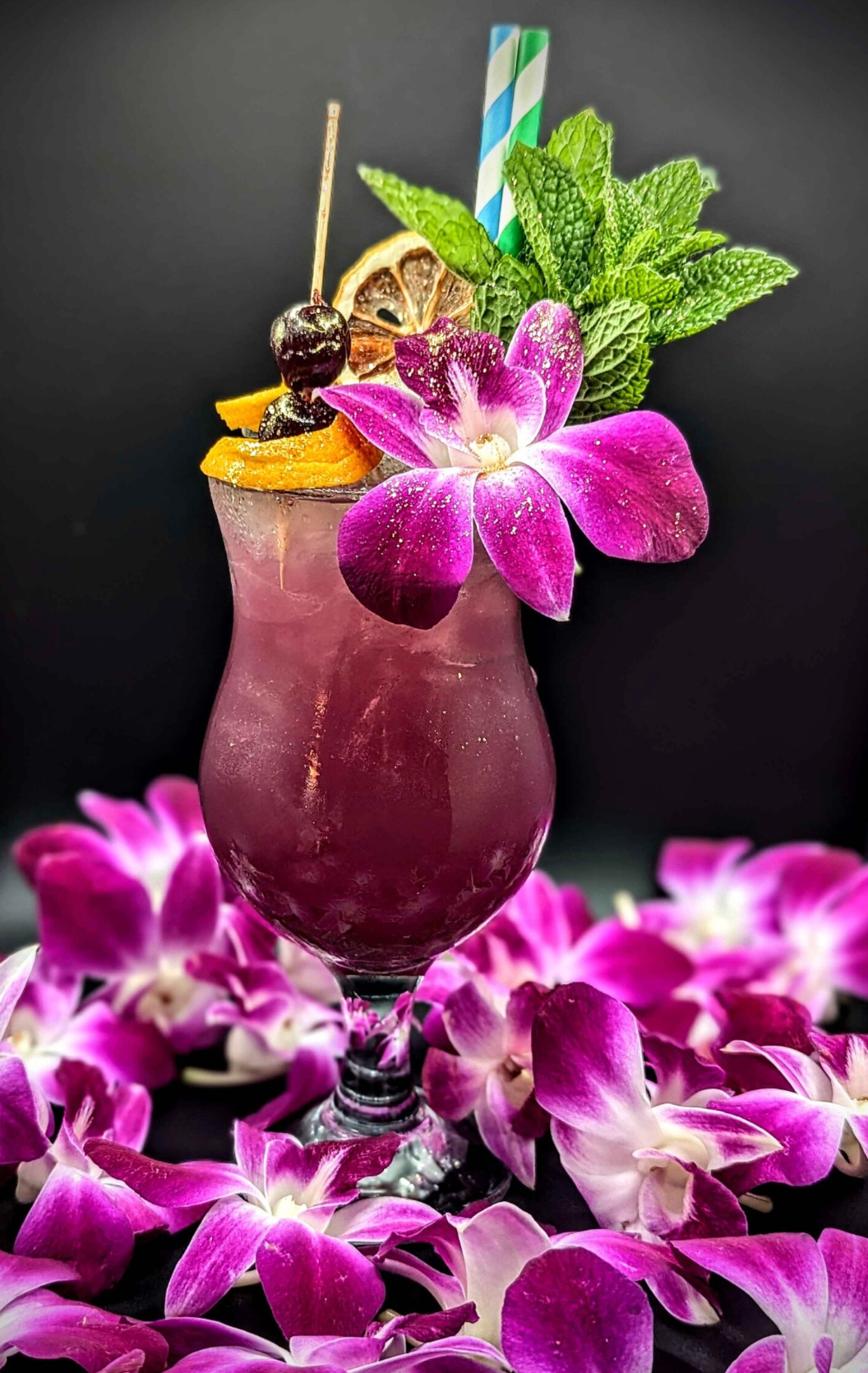 Purple cocktail decorated with flowers at Kin Lounge in downtown Gainesville, FL