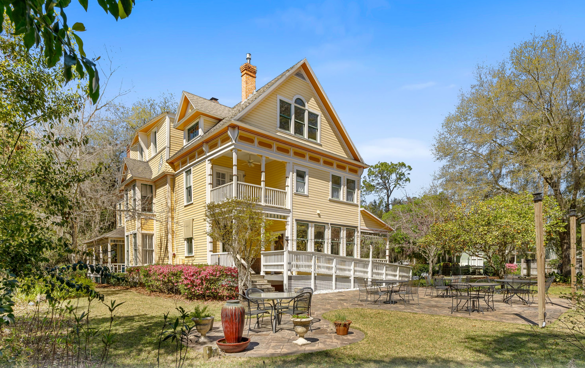 The backyard of the yellow Victorian home