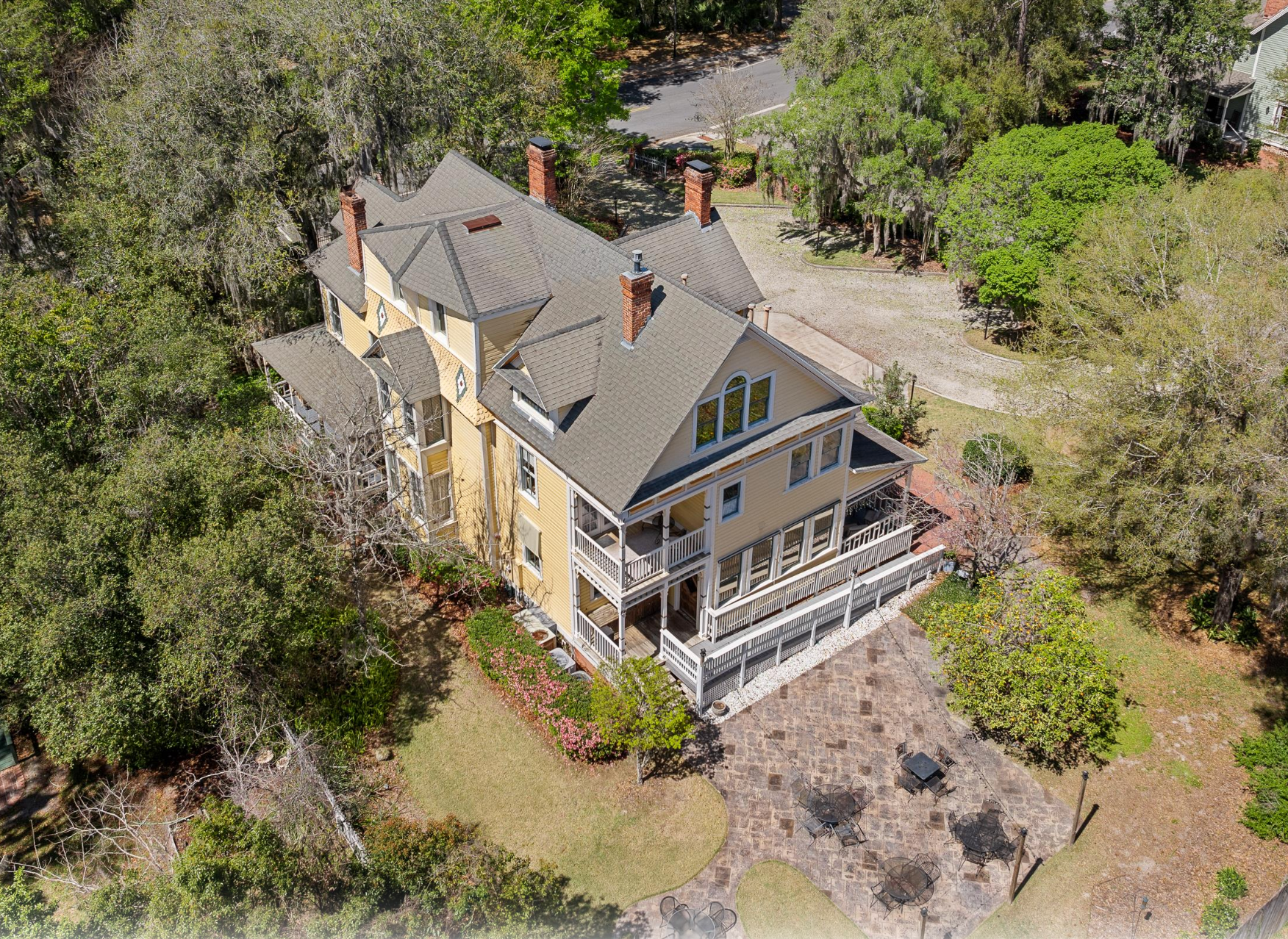 Aerial view of yellow Victorian - AirBNB, STR, and Vacation Rental