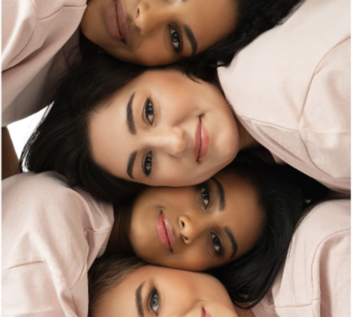 A group of women are laying on top of each other