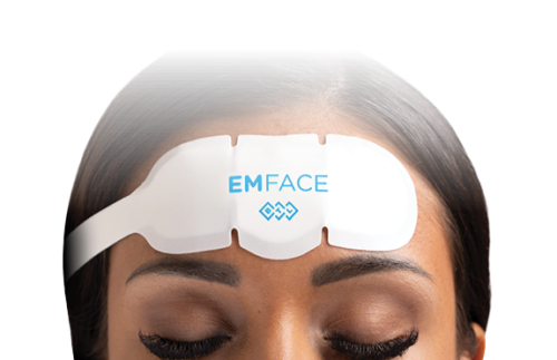 A woman is wearing a headband that says emface on it.