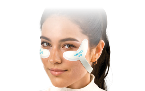 A woman is wearing a pair of eye patches on her face.