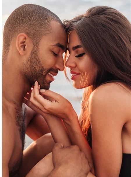 A man and a woman are looking into each other 's eyes.