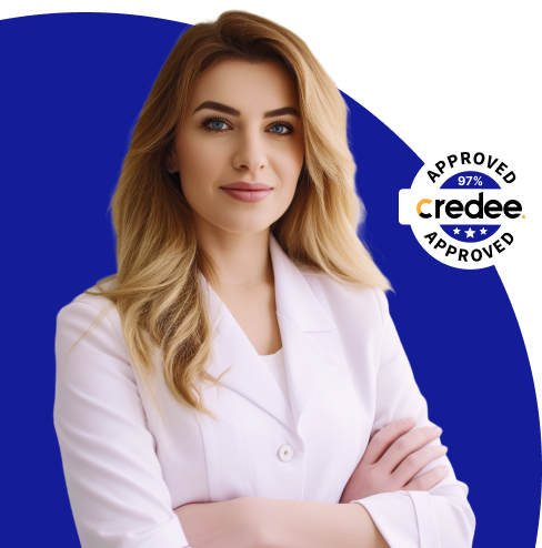 A woman in a white coat is standing with her arms crossed in front of a credee logo