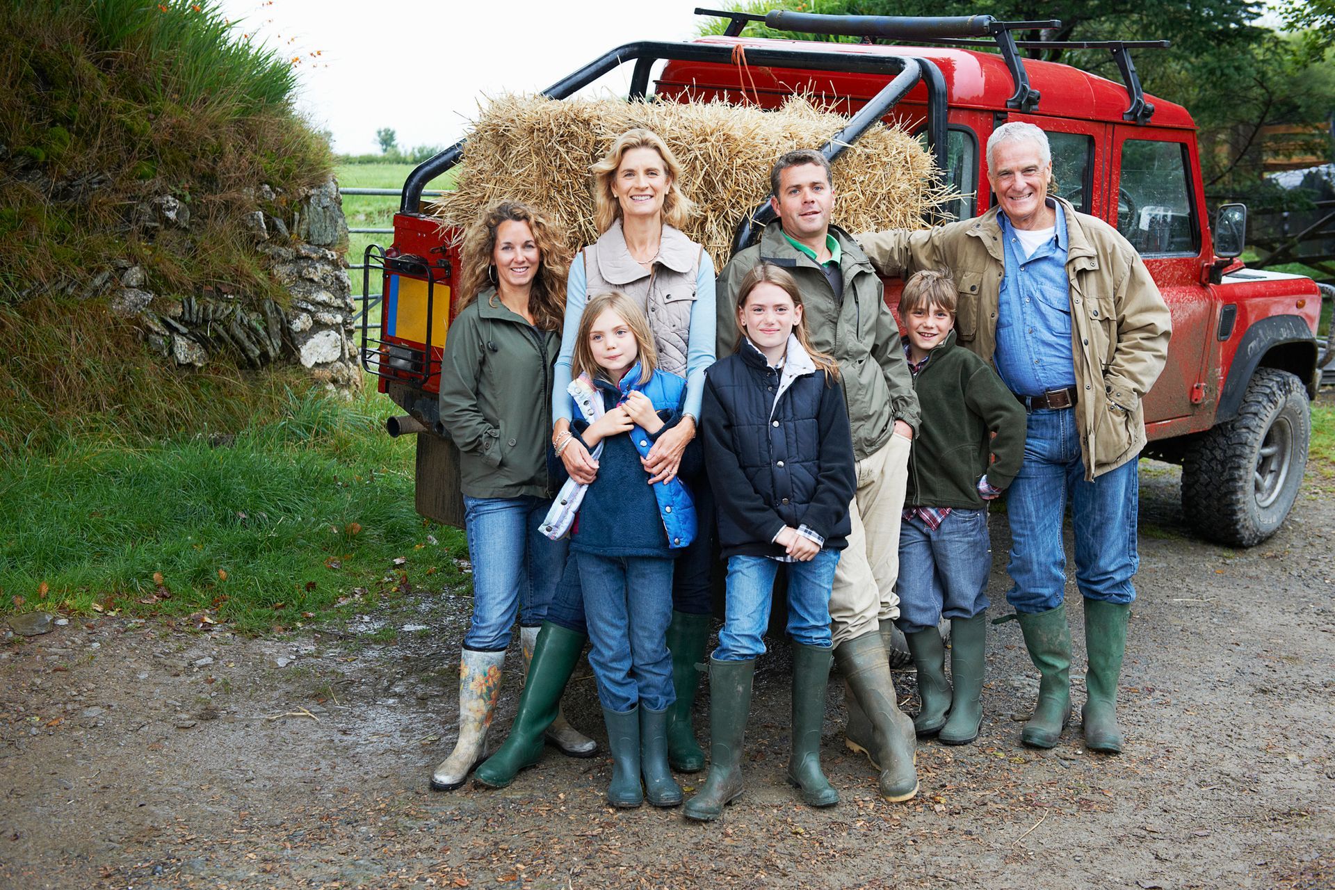 A group of people standing in front of a red truck