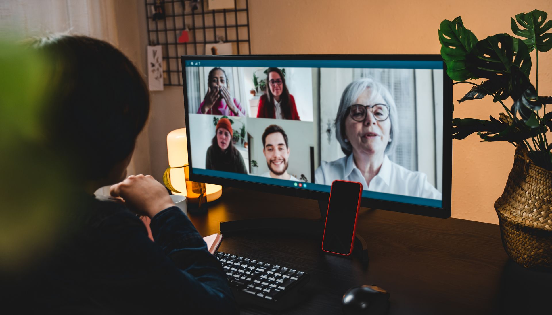A group of people are having a video call on a computer screen.