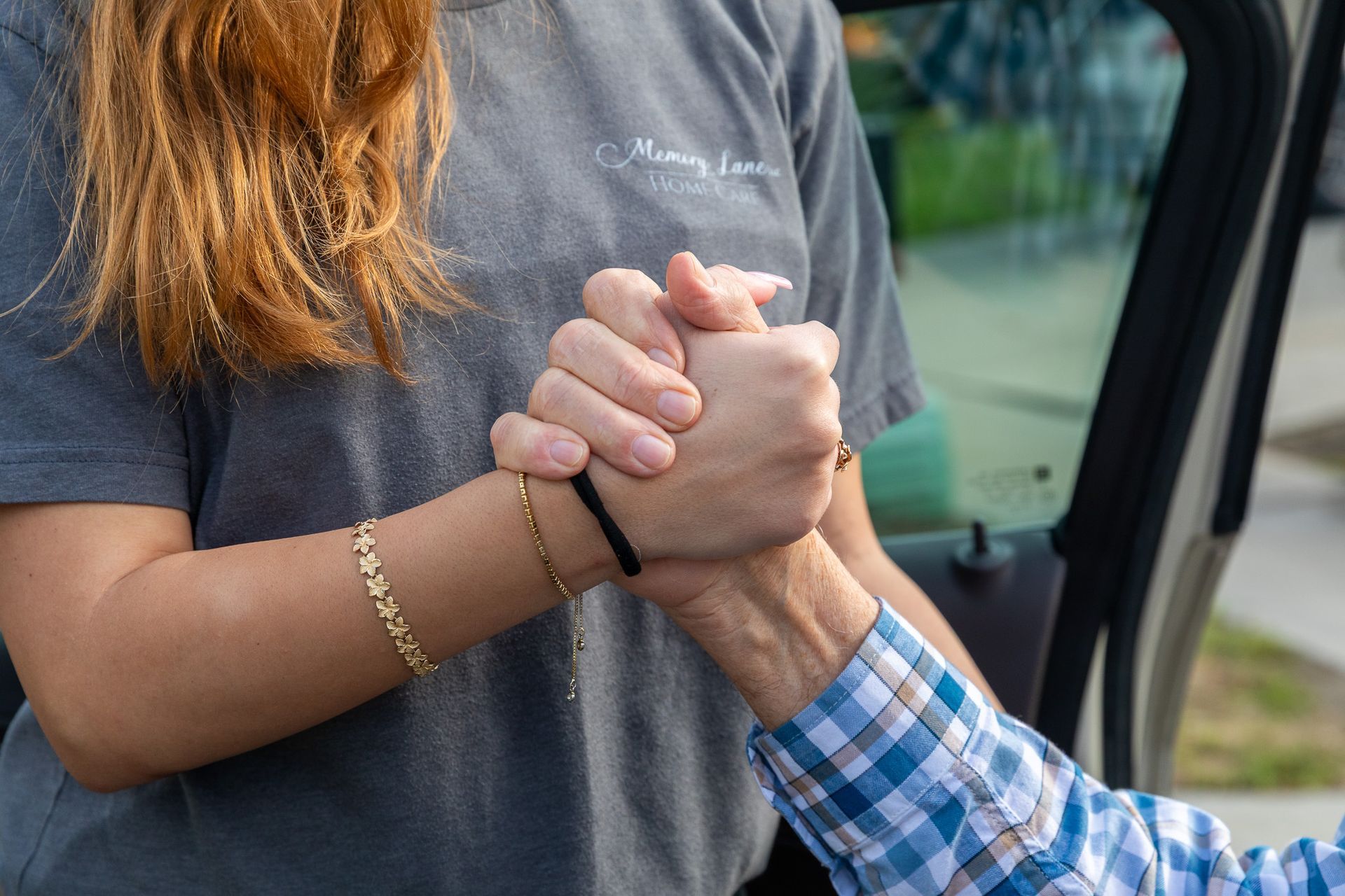 A compassionate caregiver providing support to a senior with dementia in a warm home environment.