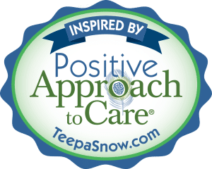 Logo for Positive Approach to Care, oval-shaped with text and a peacock feather detail. Includes the website TeepaSnow.com.