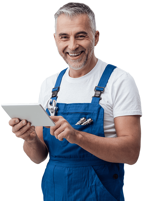 A man in blue overalls is holding a tablet and smiling.