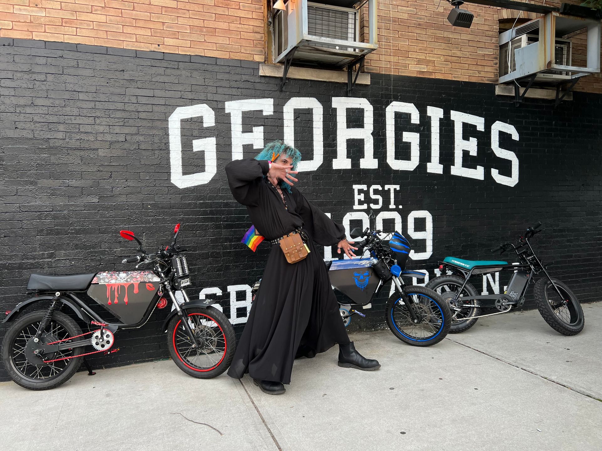 A man standing in front of a wall that says georgies
