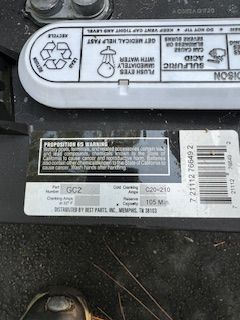 A close up of a car battery with a label that says sulfuric acid