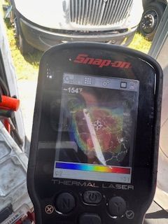 A snap on thermal laser is sitting in front of a truck.