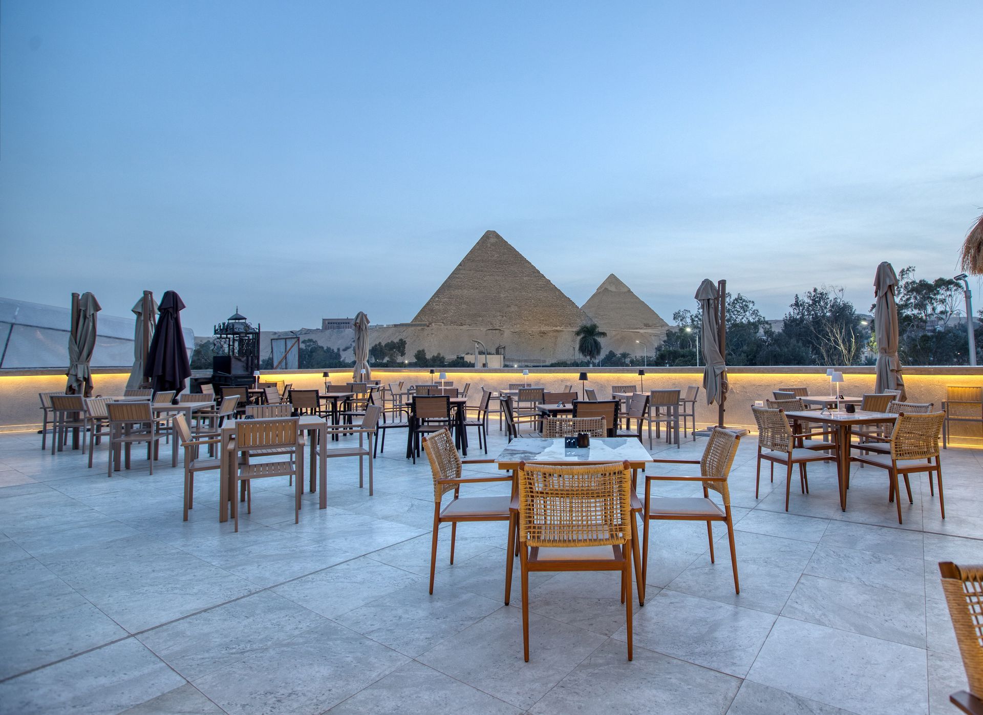 A living room with a couch , chairs and a table