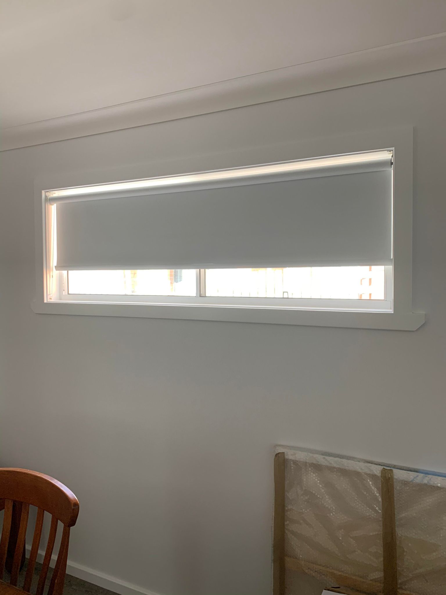 Whit Roller Blind on Window — Blinds, Awnings & Shutters in Mid North Coast, NSW